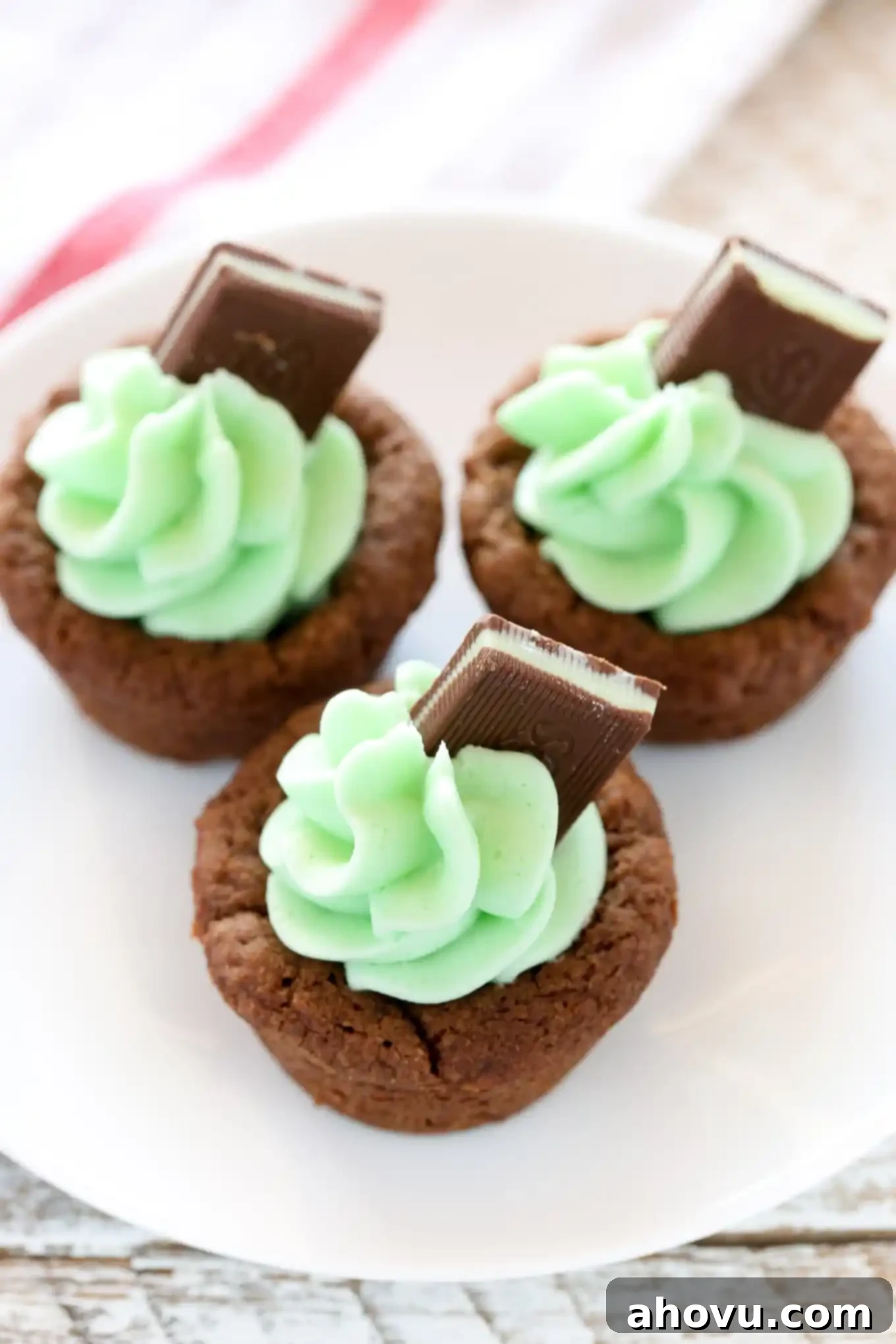 Mint Chocolate Cookie Treats 5 Piping vibrant green mint frosting into chocolate cookie cups, ready for the Andes mint garnish.