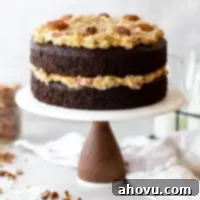 Coconut Pecan Chocolate Dream 7 A layered German Chocolate Cake on top of a marble cake stand.