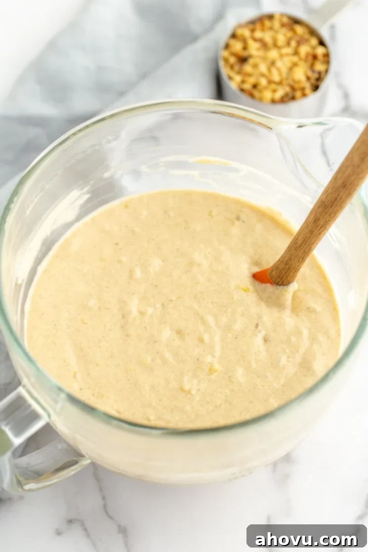 Banana Cake 4 A glass mixing bowl filled with banana cake batter. The light and airy texture of perfectly mixed banana cake batter.