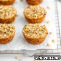 Baked banana oatmeal cups lined up on a cooling rack.