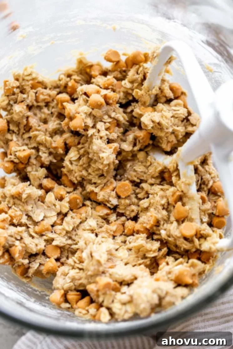 A glass mixing bowl filled with cookie dough.