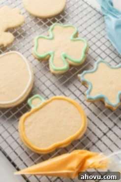 Cut out sugar cookies on a wire cooling rack, outlined with icing.
