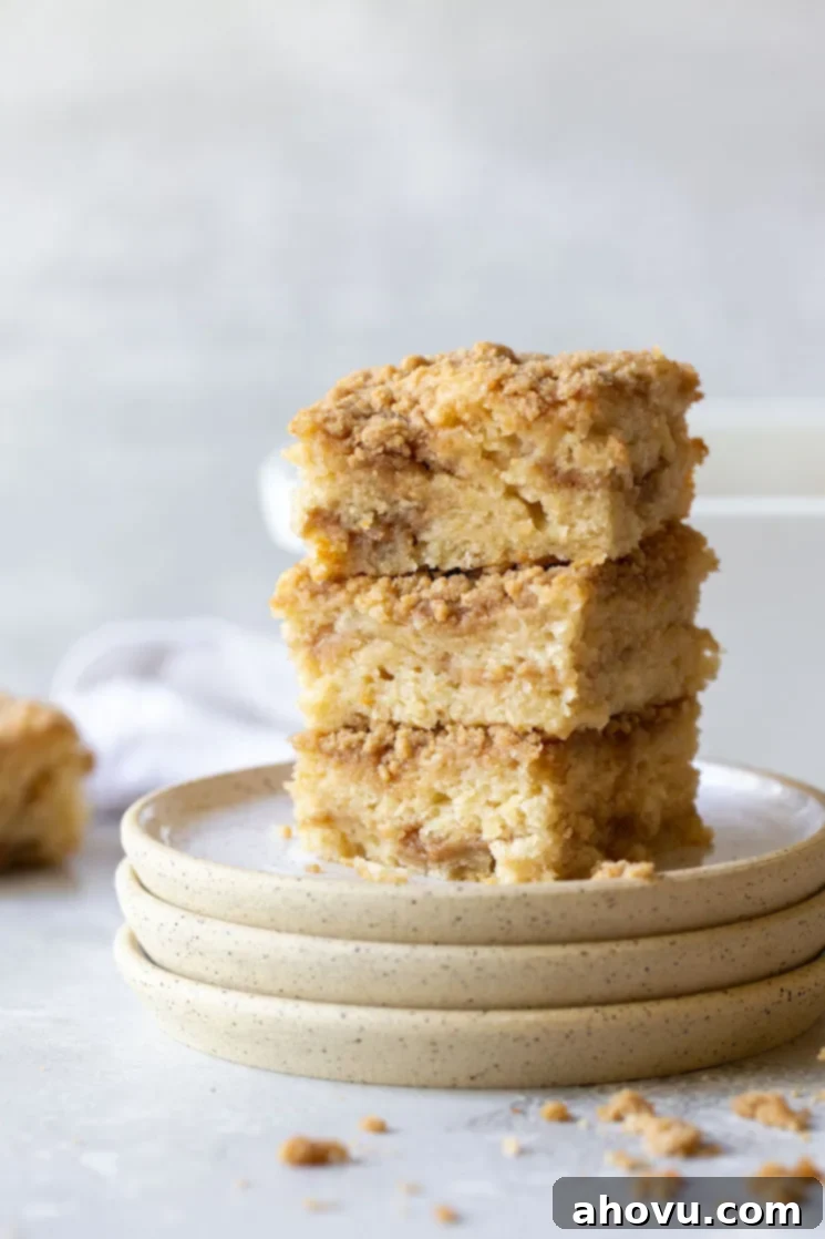A stack of coffee cake pieces showing the different layers of moist cake and crumbly streusel.