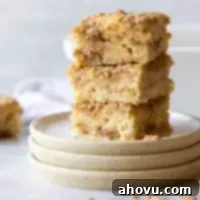 A stack of coffee cake pieces showing the cake and streusel layers.