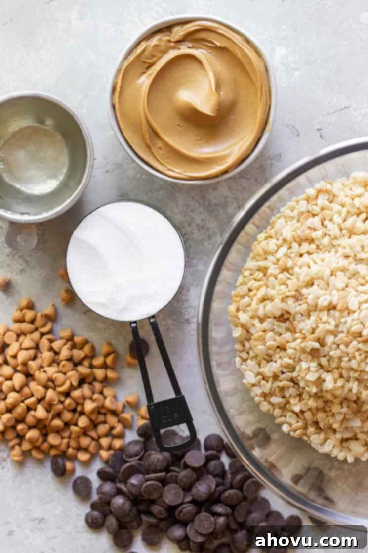 Classic Scotcheroos 3 The six core ingredients needed to make delicious Scotcheroos, including corn syrup, sugar, peanut butter, crispy rice cereal, chocolate chips, and butterscotch chips, neatly arranged on a distressed gray surface.