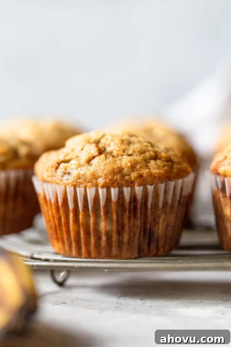 A batch of golden-brown banana muffins arranged beautifully on a round cooling rack, ready to be enjoyed.