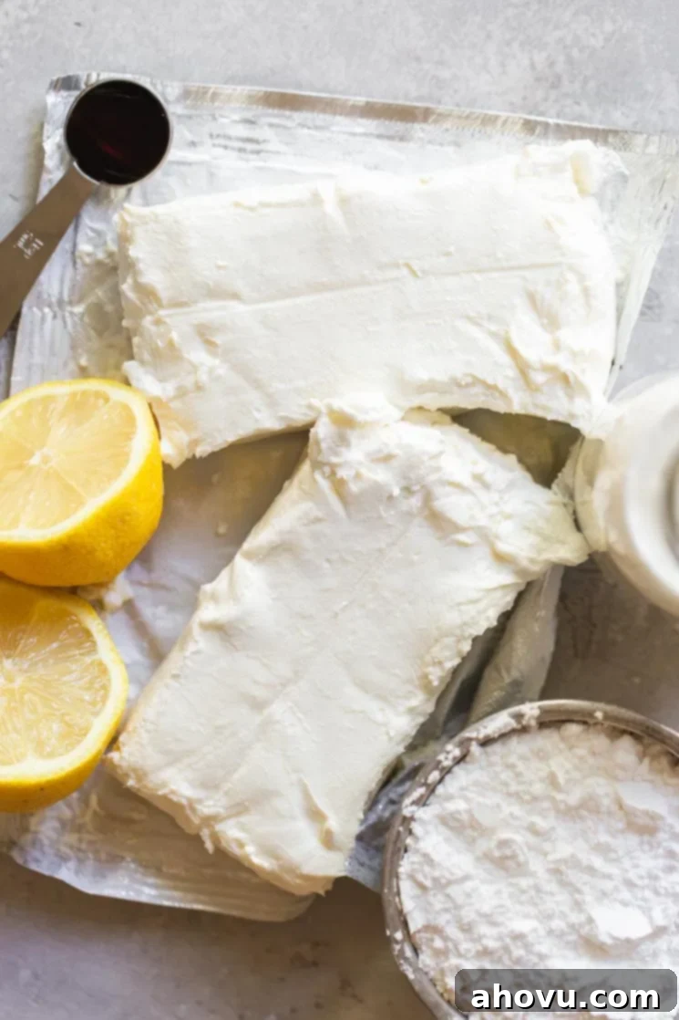 The ingredients needed to make the no-bake cheesecake filling on a rustic gray surface.