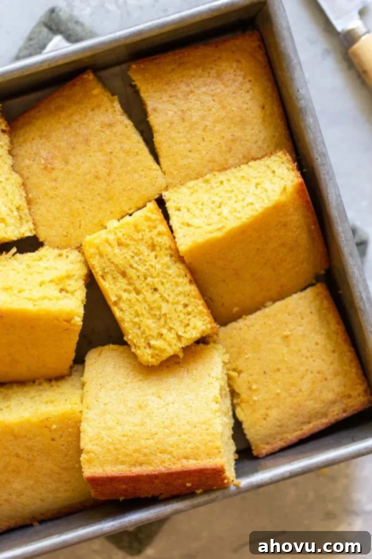 Numerous pieces of perfectly baked cornbread, some still in the pan, others artfully arranged to showcase their various golden hues and tempting textures.