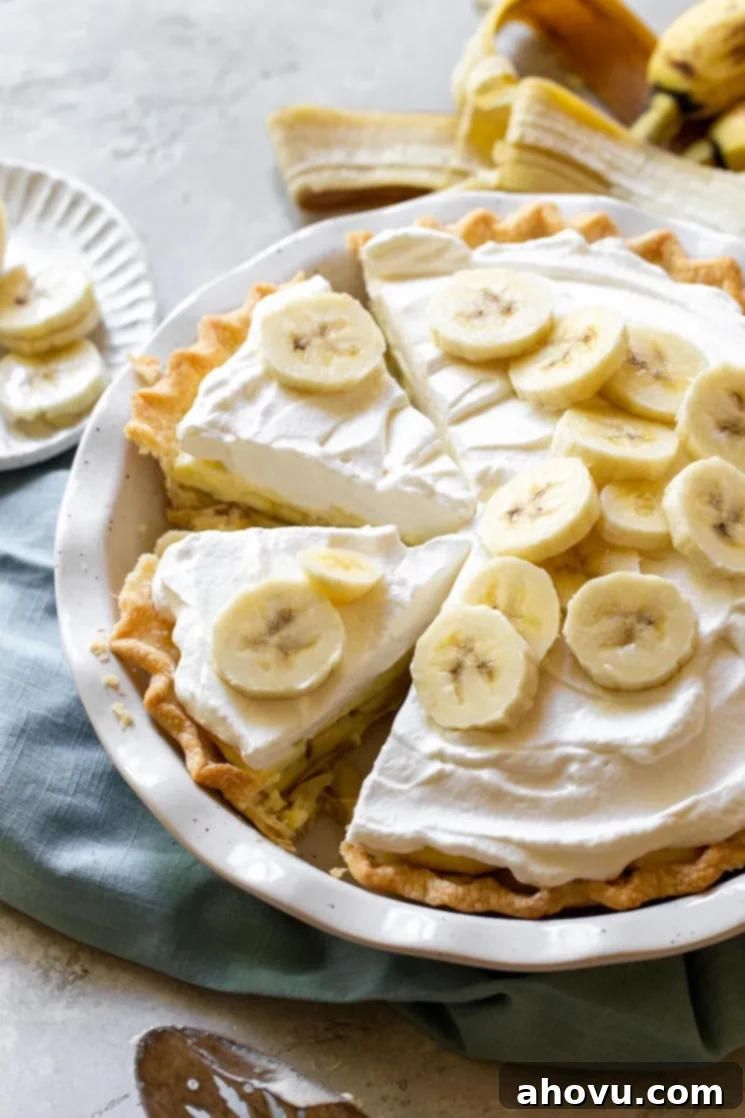 A finished banana cream pie with one piece removed and two more separated to show the layers and texture of the pie.
