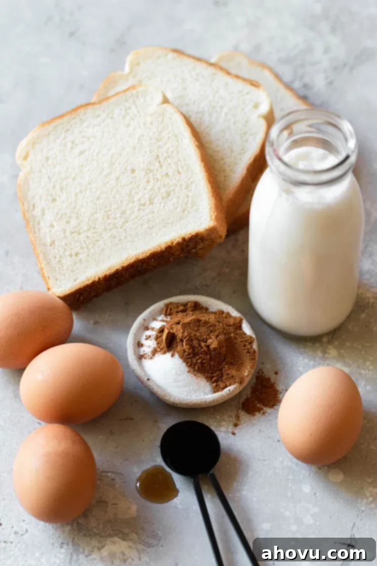 Fluffy French Toast Perfection 3 The ingredients needed to make French toast sitting on a rustic gray surface.