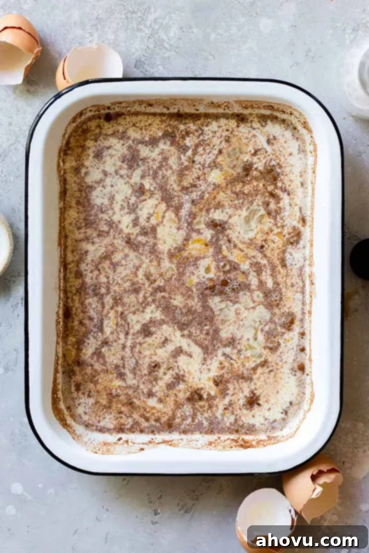Fluffy French Toast Perfection 4 A baking pan filled with the egg mixture ready to dip the pieces of bread into before cooking.