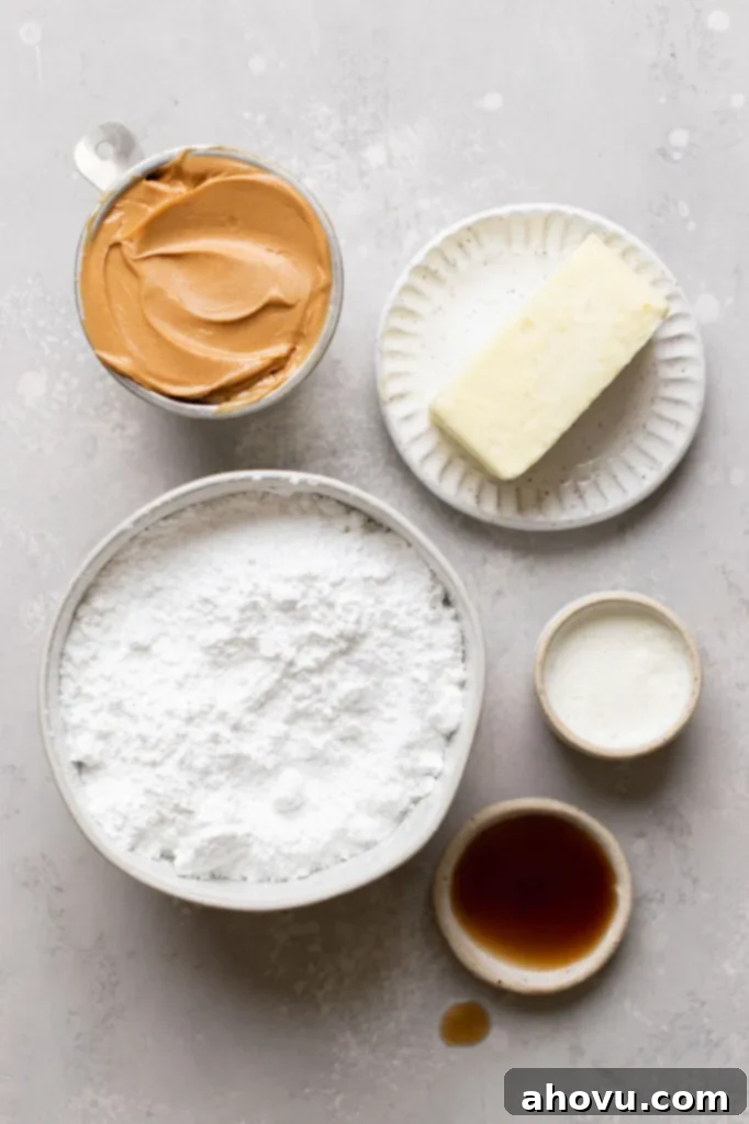 All five simple ingredients required for peanut butter frosting, neatly laid out on a clean gray surface, ready for mixing.