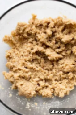 A glass mixing bowl with the mixed up butter and sugars.