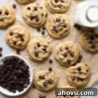 Brown butter chocolate chip cookies laid out on a brown piece of parchment paper.