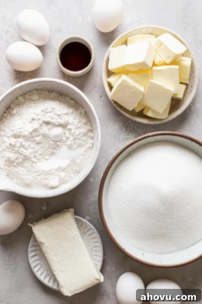 An inviting overhead view of all the essential ingredients for making cream cheese pound cake laid out neatly on a gray surface, ready for baking. Each item is perfectly positioned, suggesting an organized and enjoyable baking process.