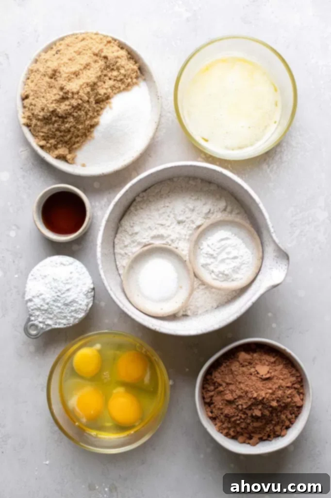 The ingredients needed to make cookies in bowls on top of a rustic gray surface.