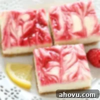 Lemon Raspberry Cheesecake Bars on a white plate