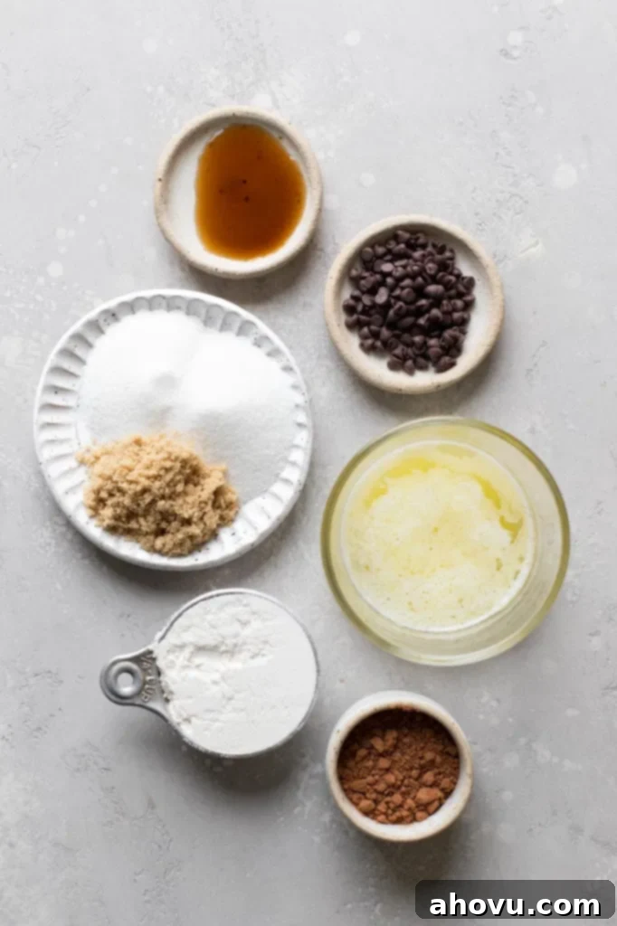 Decadent Mug Brownie 3 Overhead view of the ingredients needed to make a brownie in a mug. The ingredients are in individual dishes.