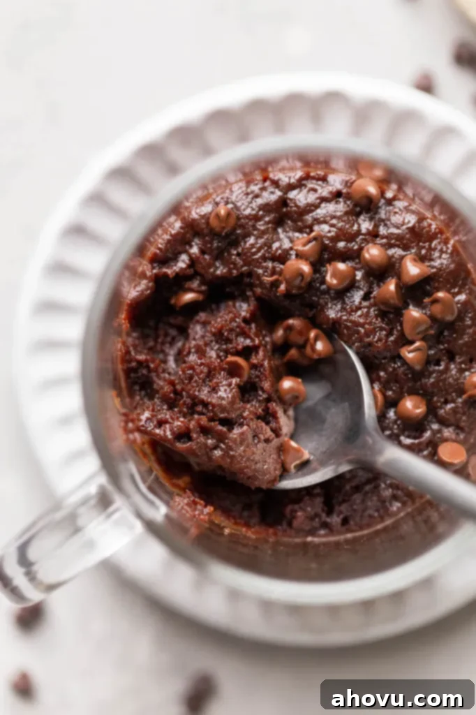 Decadent Mug Brownie 6 Close up, overhead view of a spoon digging into a microwave mug brownie.