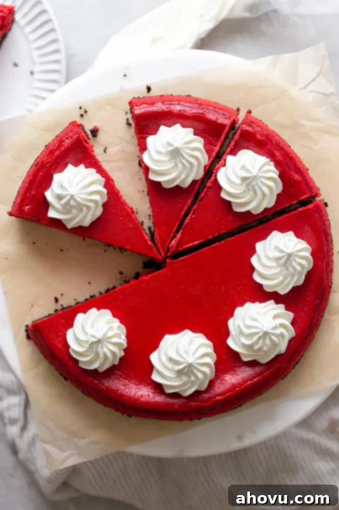 Overhead view of a red velvet Oreo cheesecake that's been partially sliced. 
