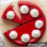 Overhead view of a red velvet Oreo cheesecake that's been partially sliced.