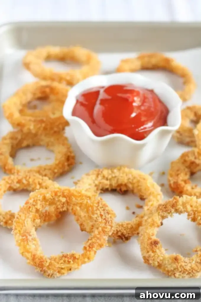 Delicious baked onion rings served on a plate, ready to eat.