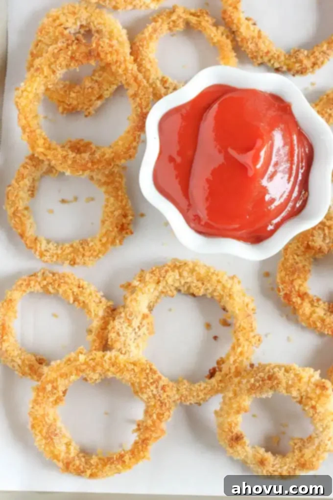 Onion rings soaking in buttermilk in a baking dish, a key step for tenderness.