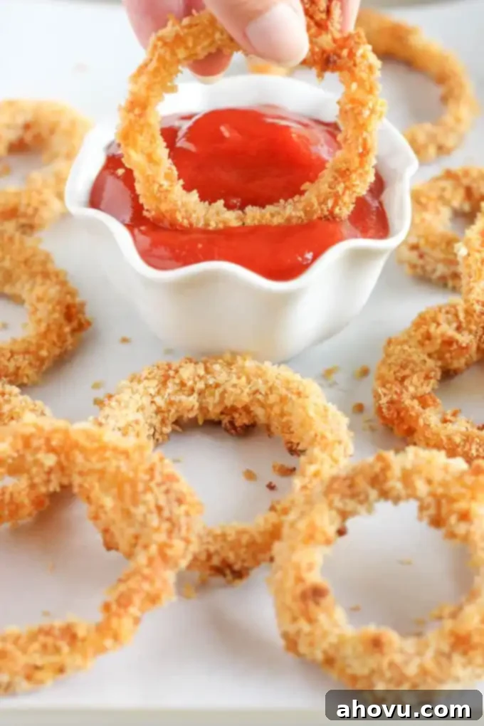 Three bowls showing the breading station for baked onion rings: flour, egg wash, and panko breadcrumbs.
