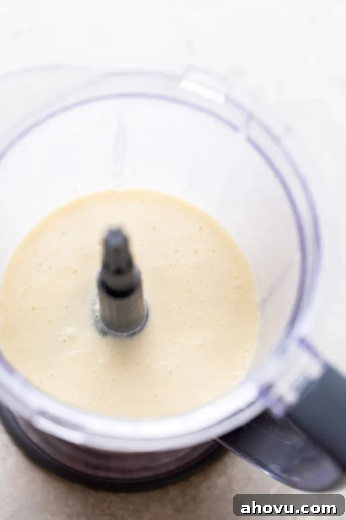 Overhead view of crepe batter in a blender. 