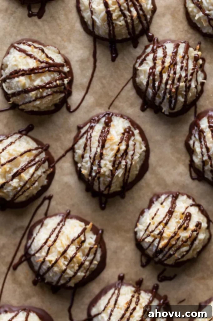 Overhead view of chocolate coconut macaroons on parchment paper, ready to be enjoyed.
