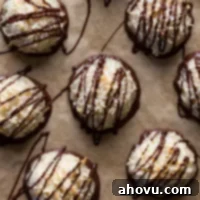 Overhead view of chocolate coconut macaroons on parchment paper.