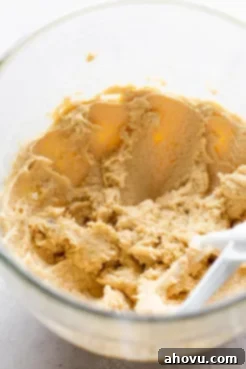 A glass mixing bowl of cookie dough.