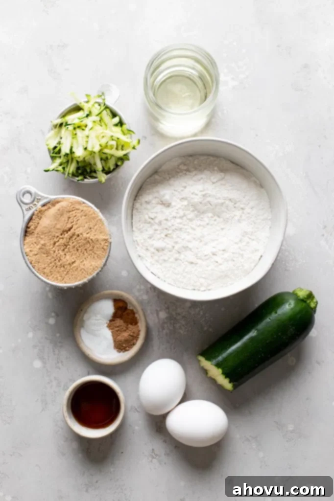 An overhead view of the ingredients needed to make homemade zucchini muffins. 