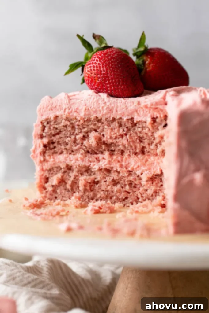 A close-up picture of a sliced strawberry cake, revealing its moist, tender crumb and layers of strawberry goodness.