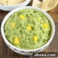 This mango guacamole makes a fun appetizer for any party and comes together in just a few minutes!  Serve it with some tortilla chips for a quick and easy appetizer or snack.