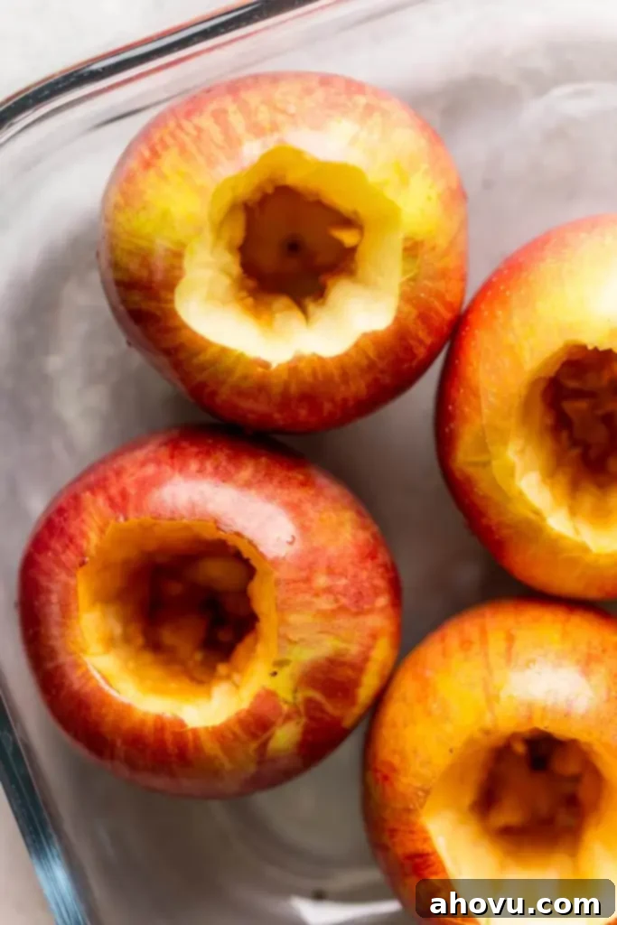 An overhead view of raw apples that have been cored. 