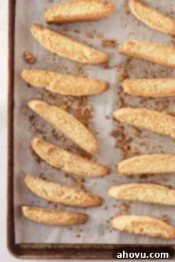 An overhead view of classic biscotti cookies on a baking sheet.