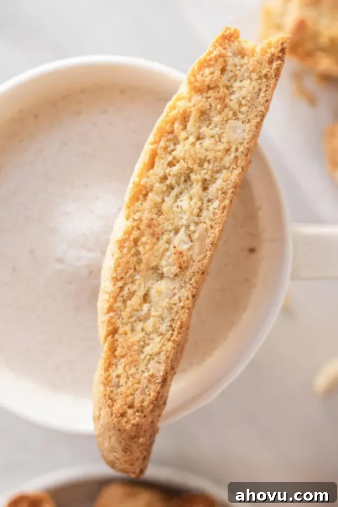Homemade Almond Biscotti Perfection 5 An overhead view of a biscotti cookie resting on the edge of a mug of coffee.