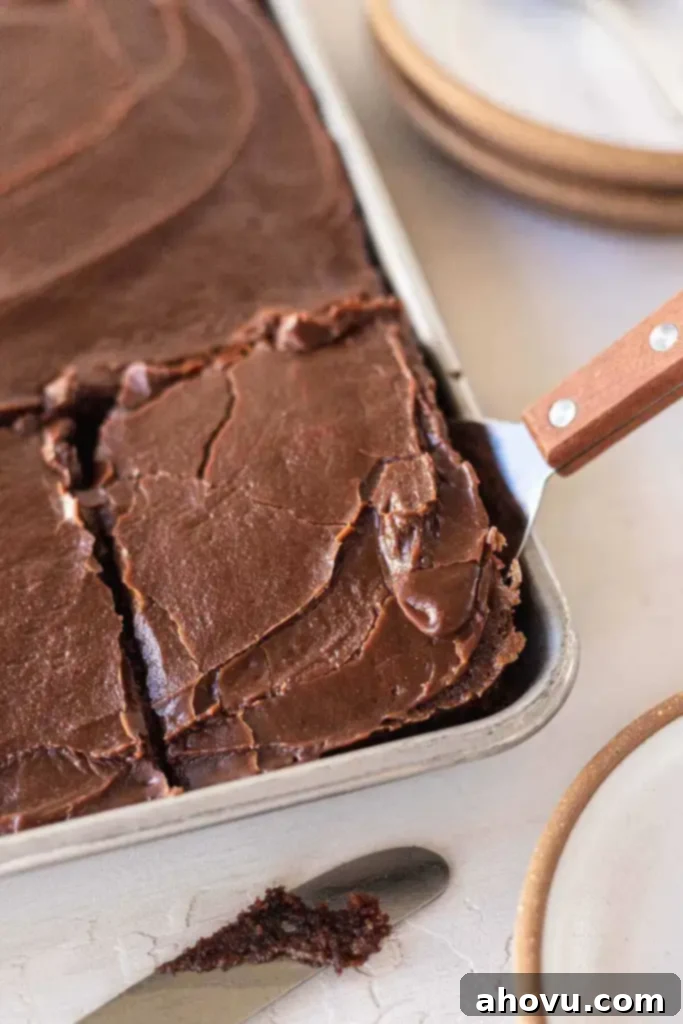 A slice of Texas sheet cake being removed from the pan. 