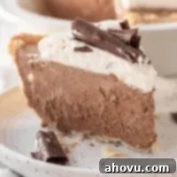 Decadent French Silk Pie 6 A slice of French silk pie topped with homemade whipped cream and chocolate curls.