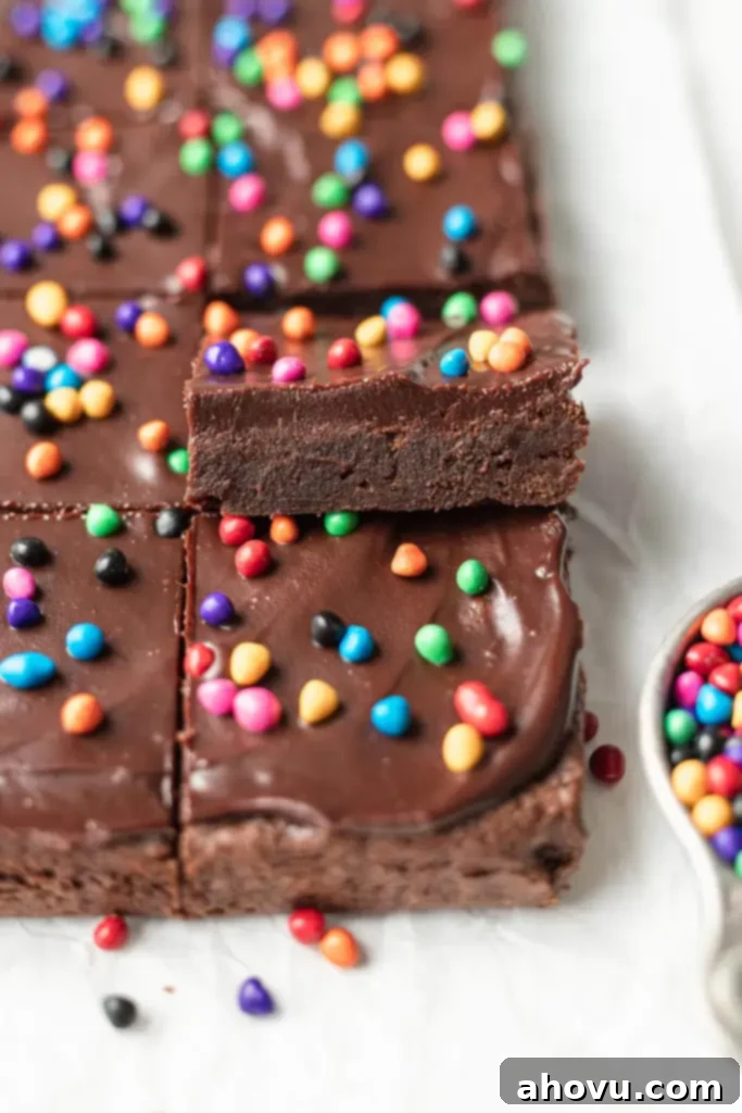 Two rows of sliced homemade Cosmic Brownies, with one brownie tipped up onto the others. 