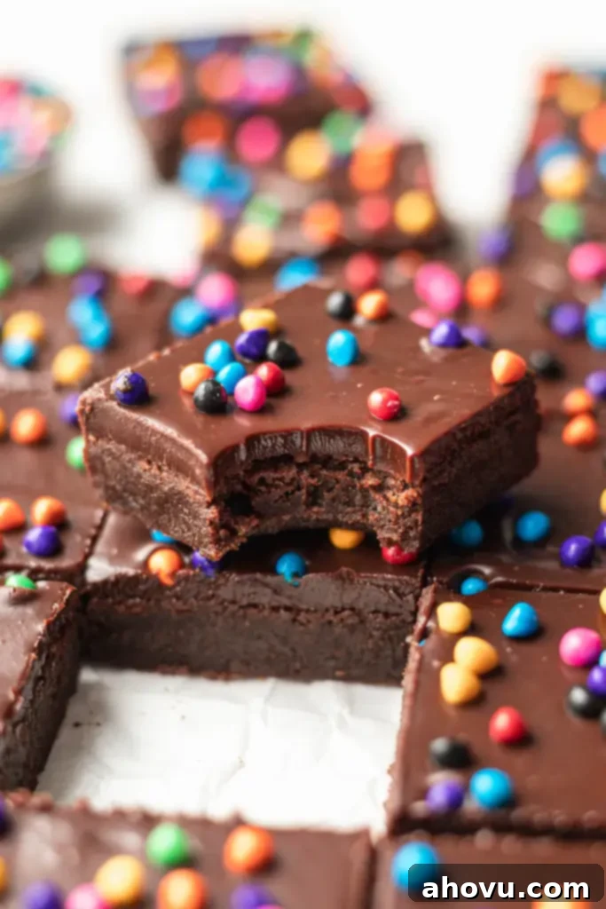An angled view of cosmic brownies. One is stacked on another and has a bite taken out of it.