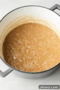 A pot filled with a bubbling butter-sugar mixture.