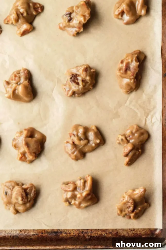 An overhead view of soft pralines on a parchment-lined baking sheet. 