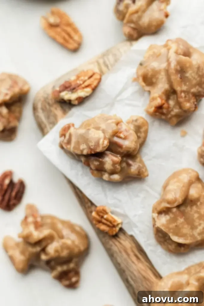 An overhead view of southern pralines on a wood serving board on a countertop. 