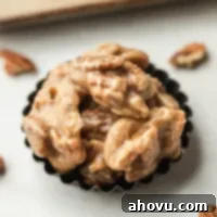 Several pecan pralines in a small tin.