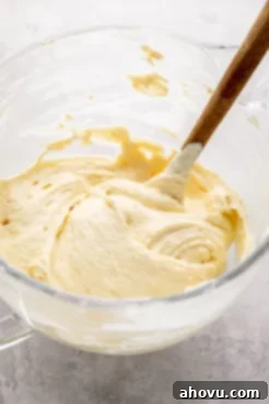 Cake batter mixed together in a large glass mixing bowl.