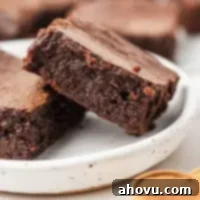 A perfectly baked small batch brownie on a white plate, showcasing its rich, fudgy texture.