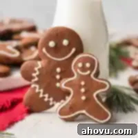 Beautifully iced gingerbread men cookies artfully arranged with a small jug of milk, ready for a festive holiday serving.