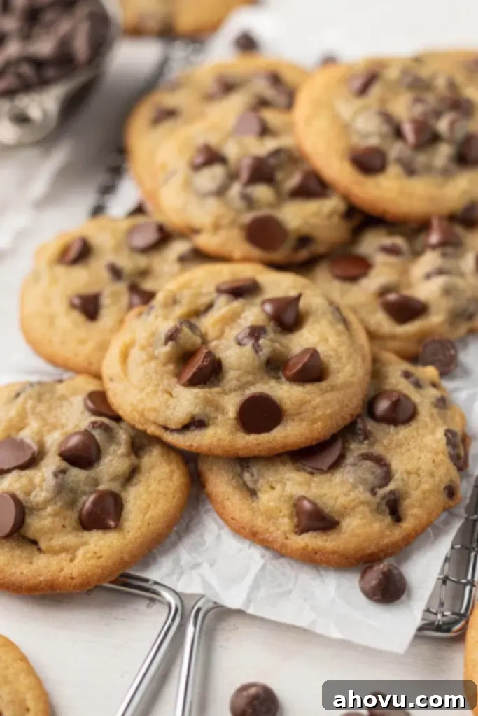 A pile of pudding cookies on a parchment-lined wire cooling rack. 